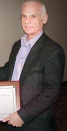 Larry Roberts (circa 2000) holding a plaque/award