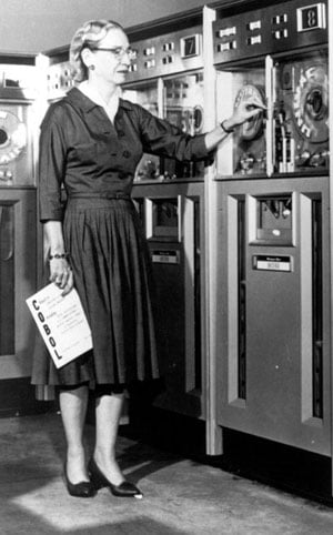 Grace Hopper holding a COBOL manual.