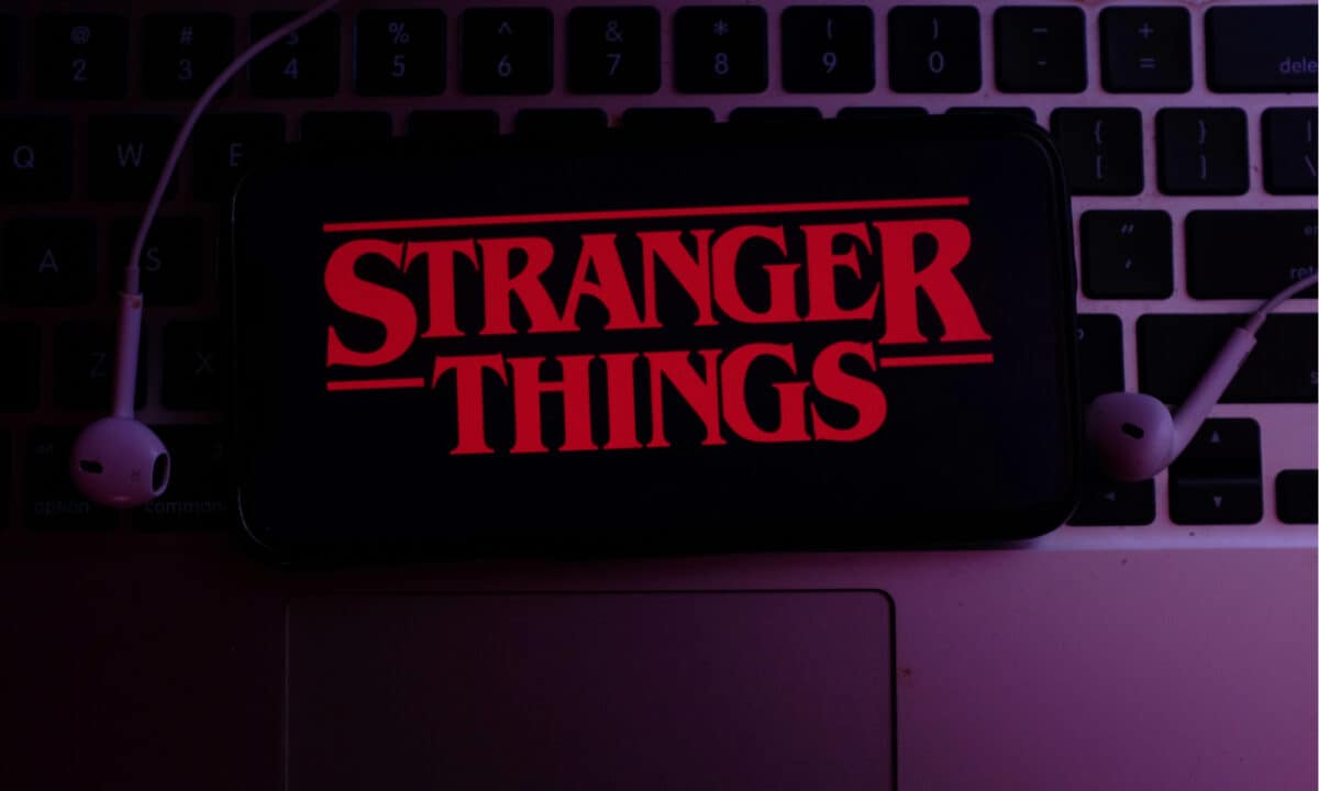 Stranger Things logo on an iPhone resting on a keyboard.