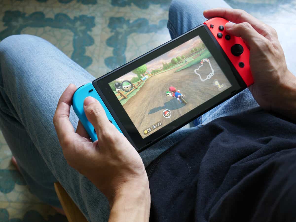 Nintendo Switch And Small Nintendo Switch Lite Comparison Of Two Handheld  Game Consoles Stock Photo - Download Image Now - iStock