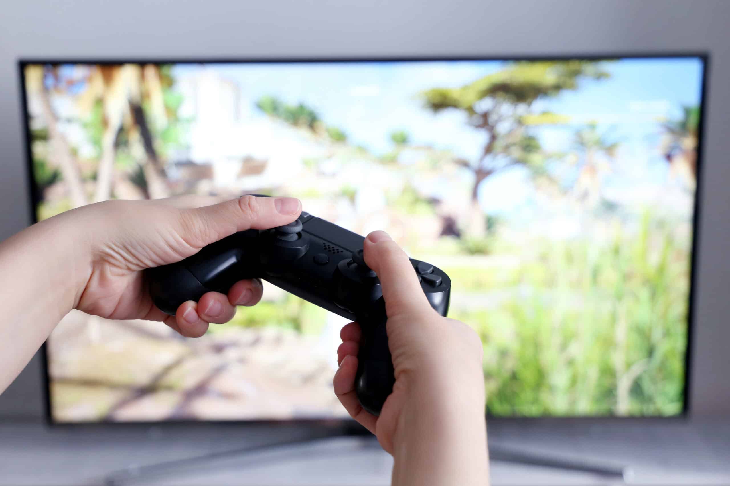 Person playing video games on high-resolution tv
