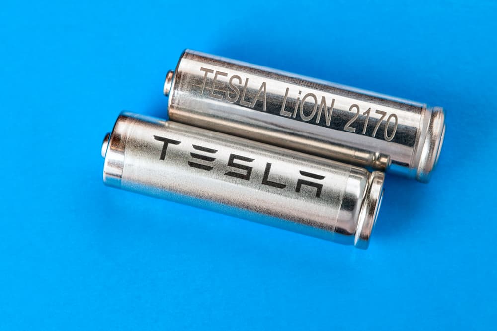 a pair of 2170 batteries on a light blue background