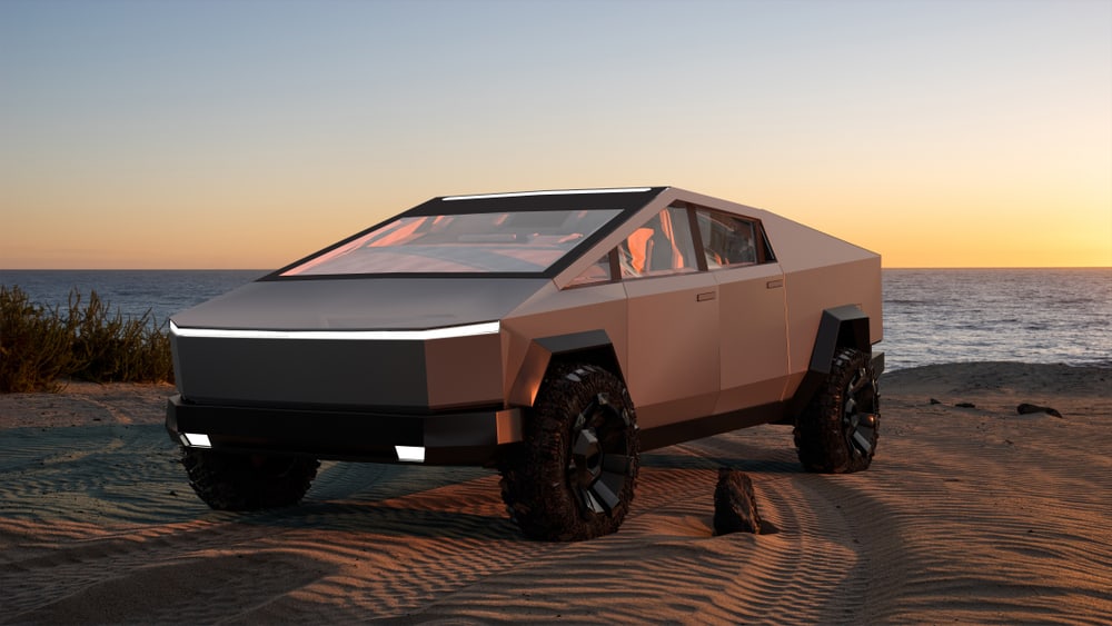  Tesla Cybertruck electric pick-up parked on a sandy beach close to the sea