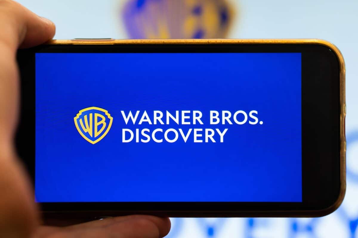 Warner Bros. Discovery logo on smartphone screen.