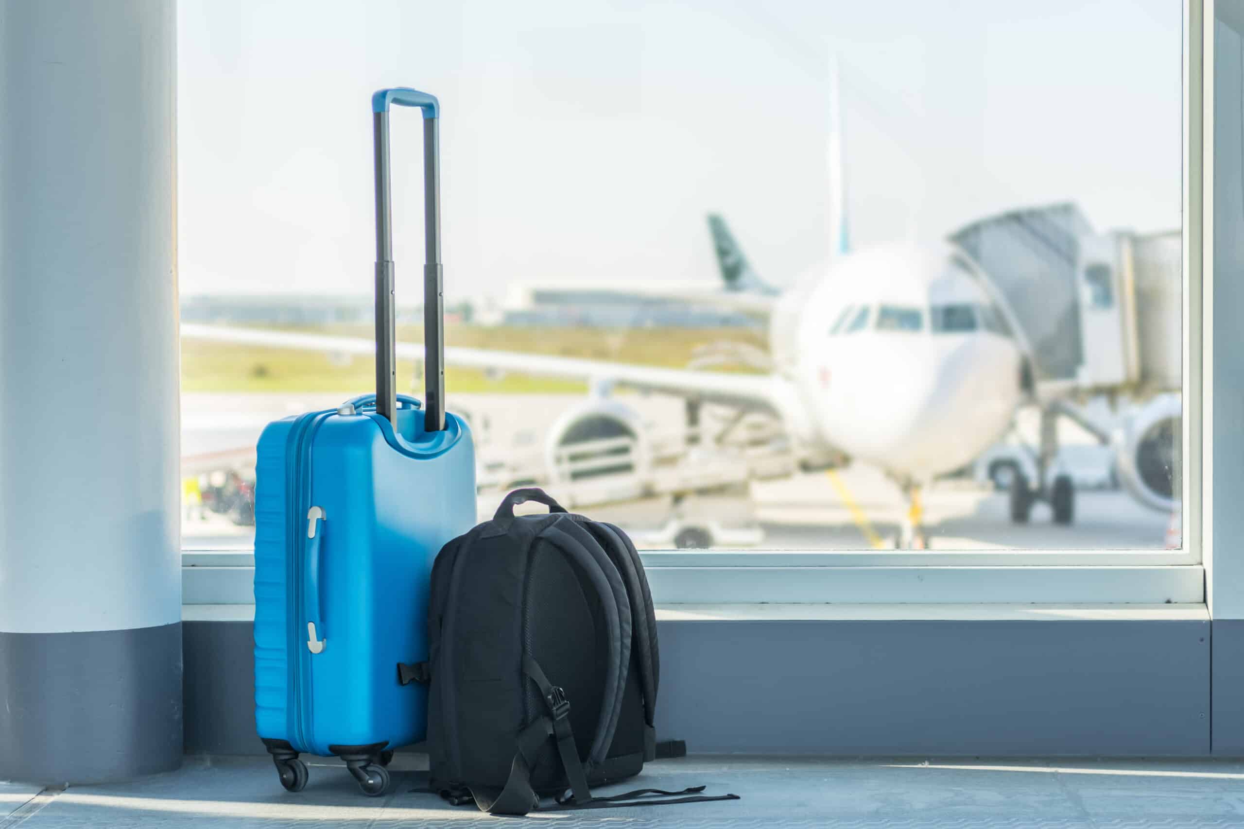 Carry-on in front of a plane airport