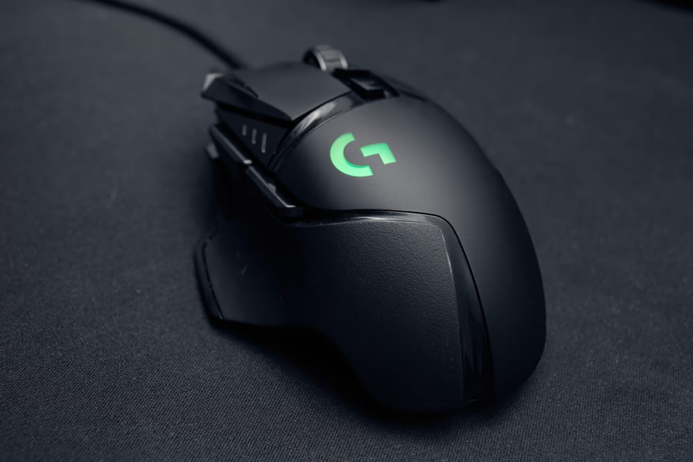 a black logitech wired mouse on a pad