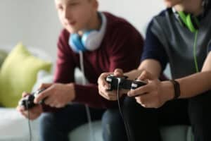 Teenagers playing video games controllers