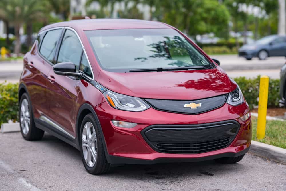 Maroon chevrolet bolt EV at a parking area