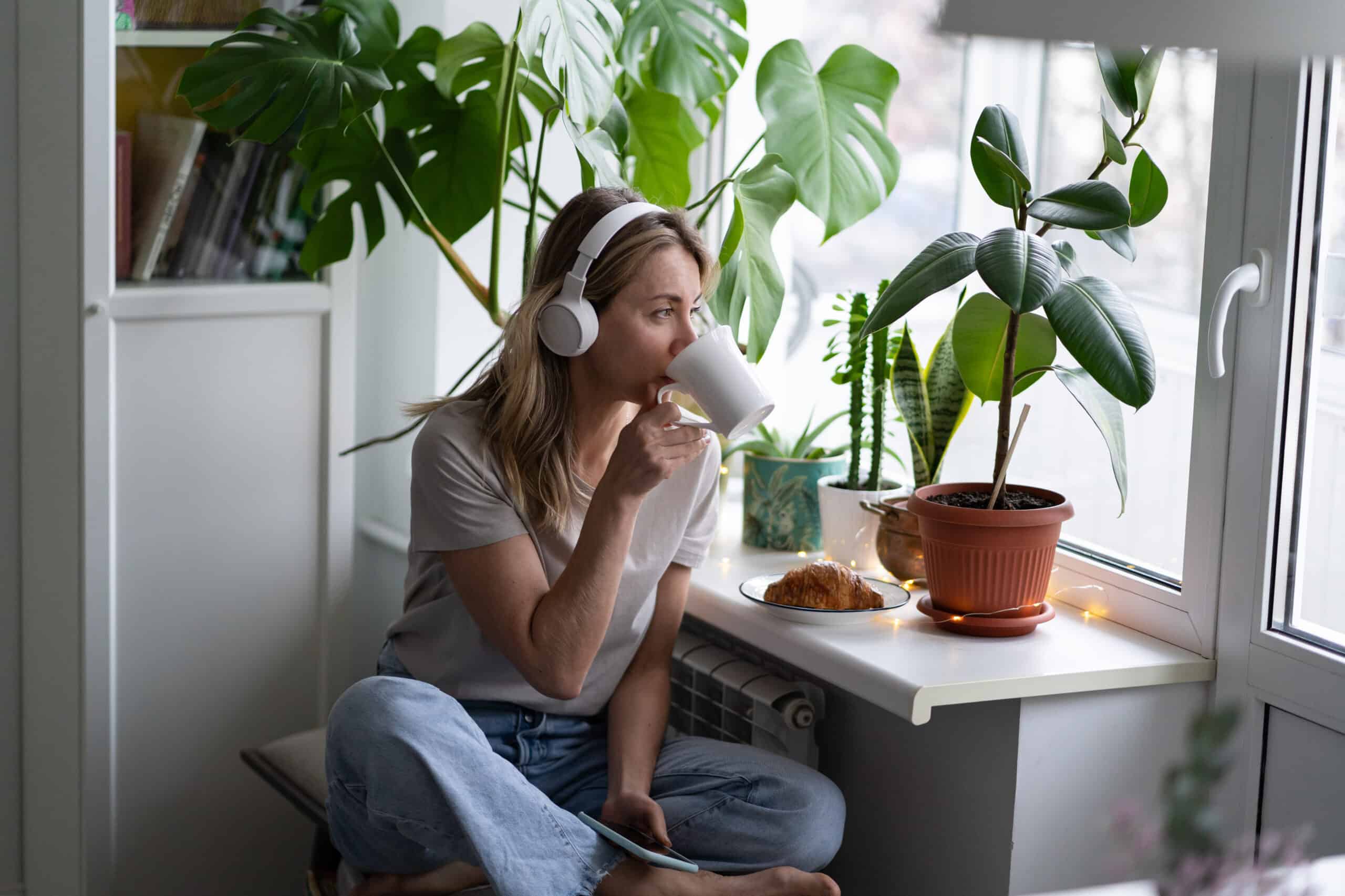 Woman at desk listening to podcast music