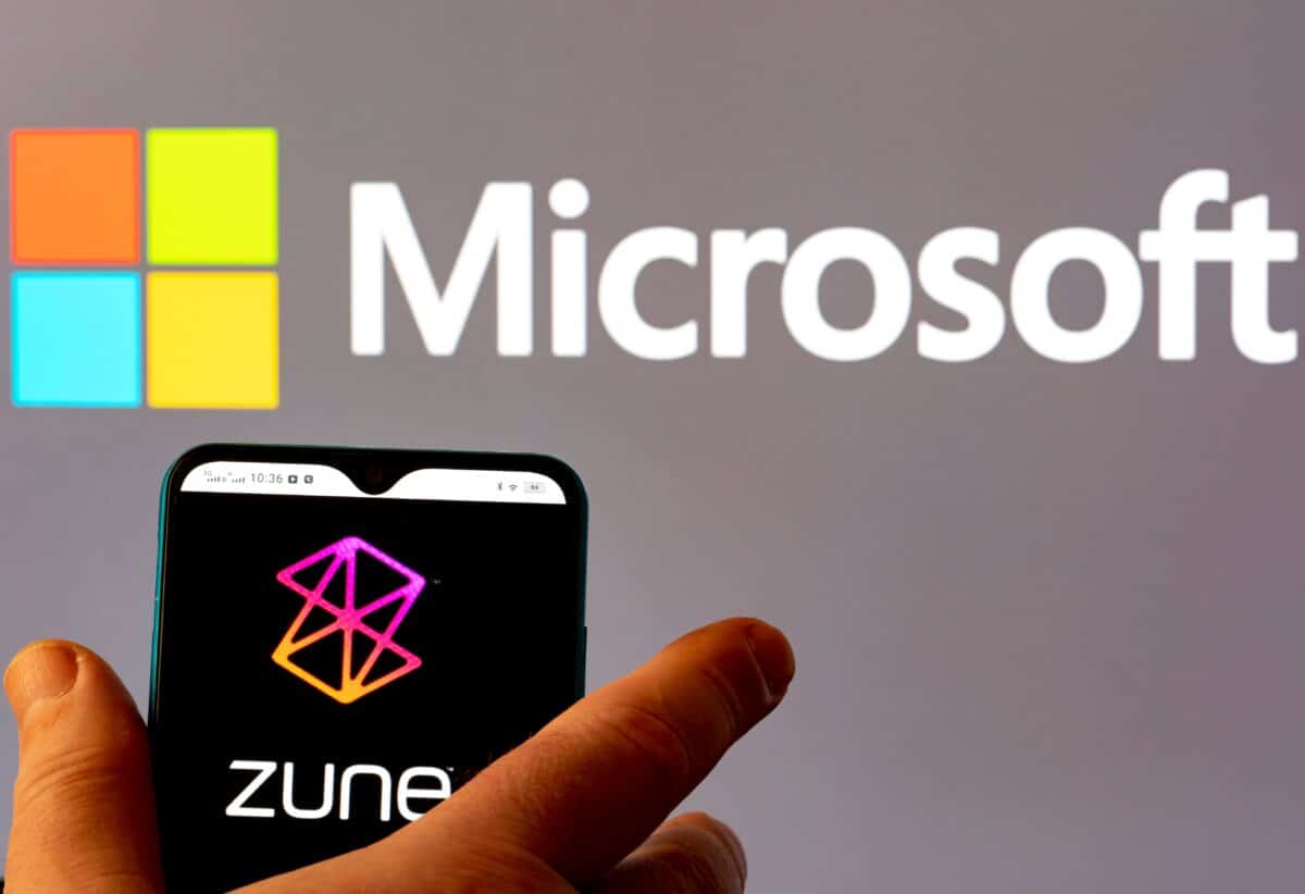 Zune logo on a smartphone with microsoft logo on the backrgound