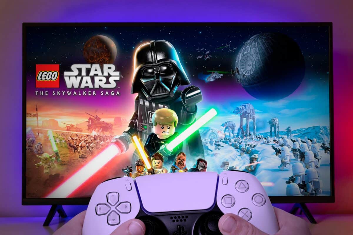 Video game controller in front of Lego Star Wars the Skywalker Saga