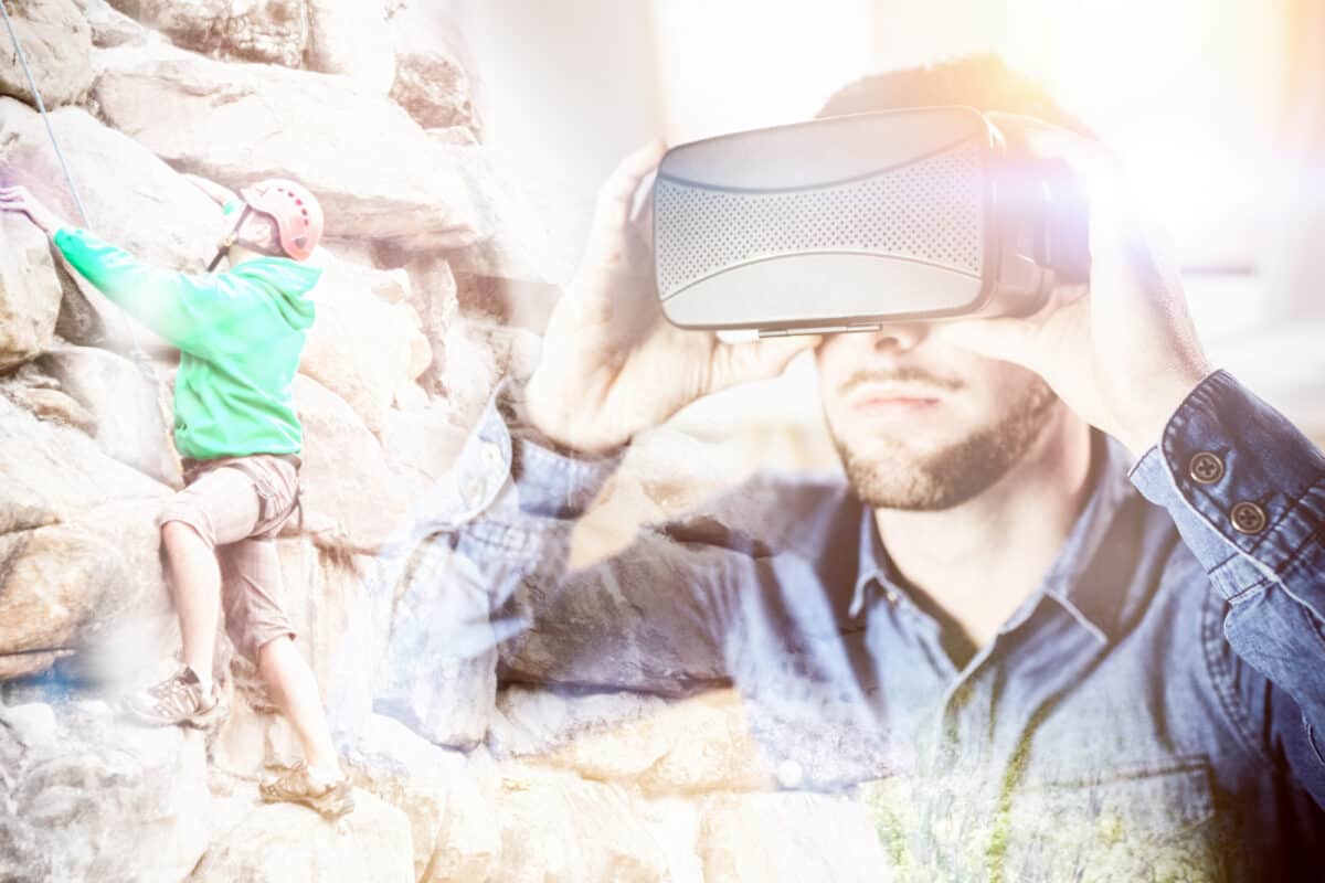 Man playing VR game mountain climbing