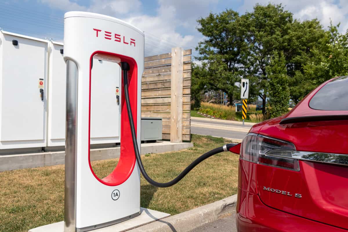 A Tesla vehicle charging at a Tesla charger