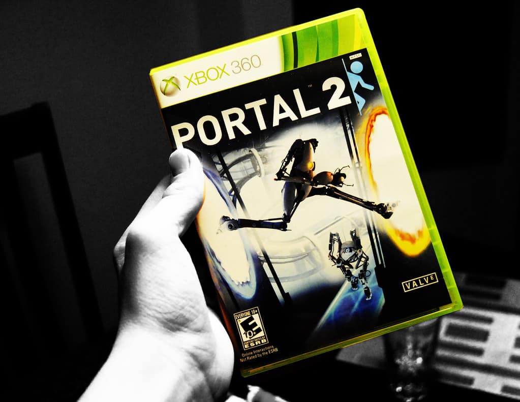 hand holding Portal 2 game cover