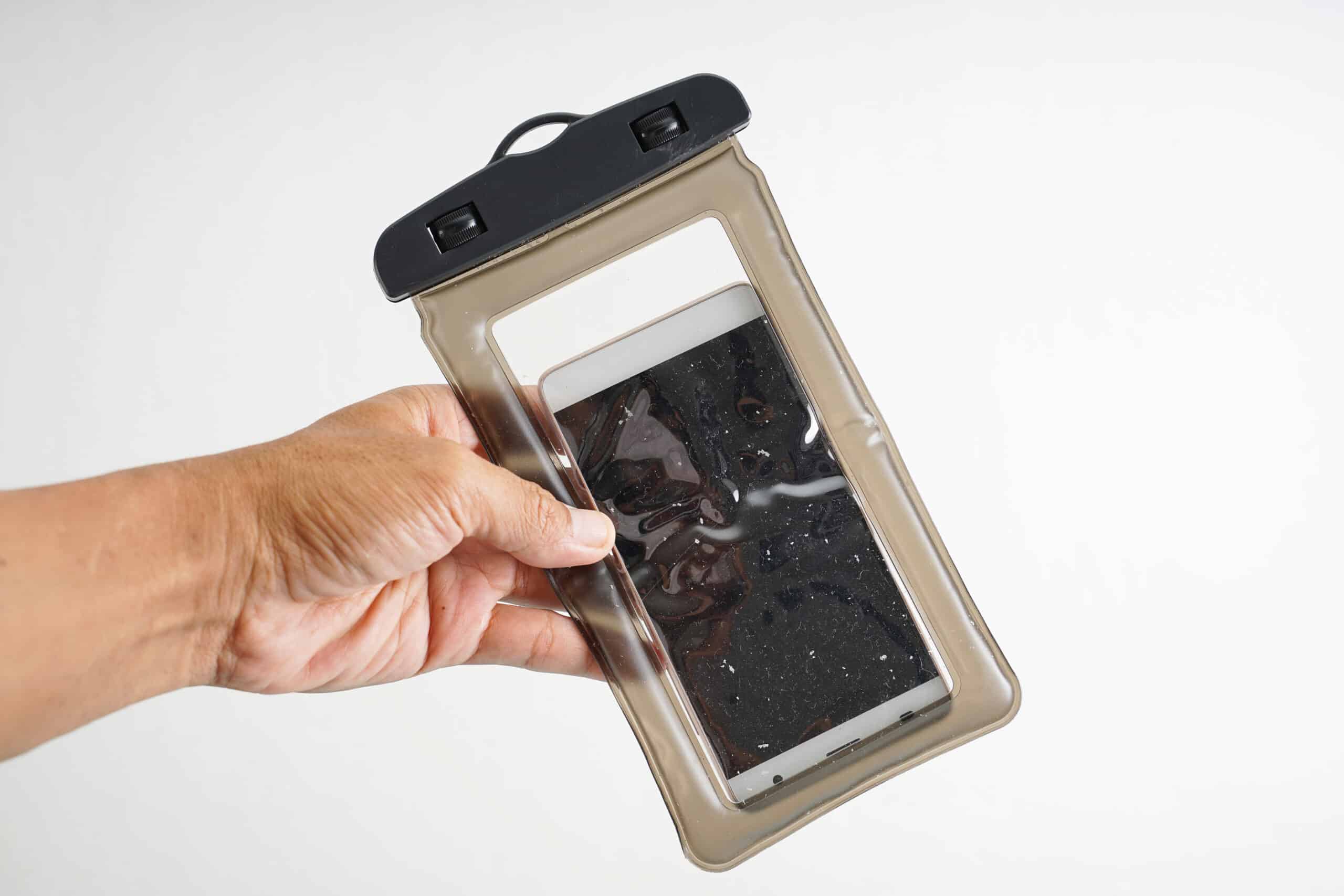 hand holding a waterproof case with a phone