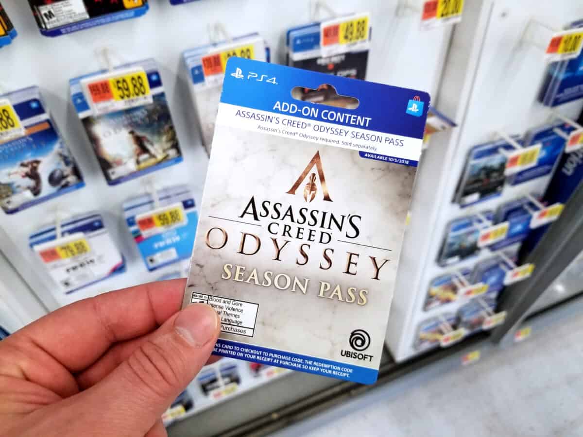 buyer holding Assassins Creed Odyssey video game