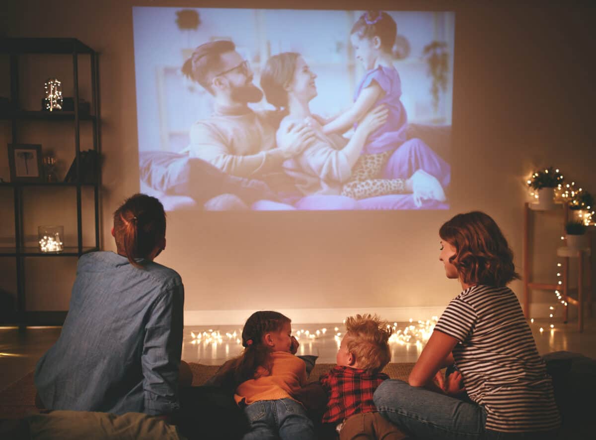 Projector displays family photos on wall.