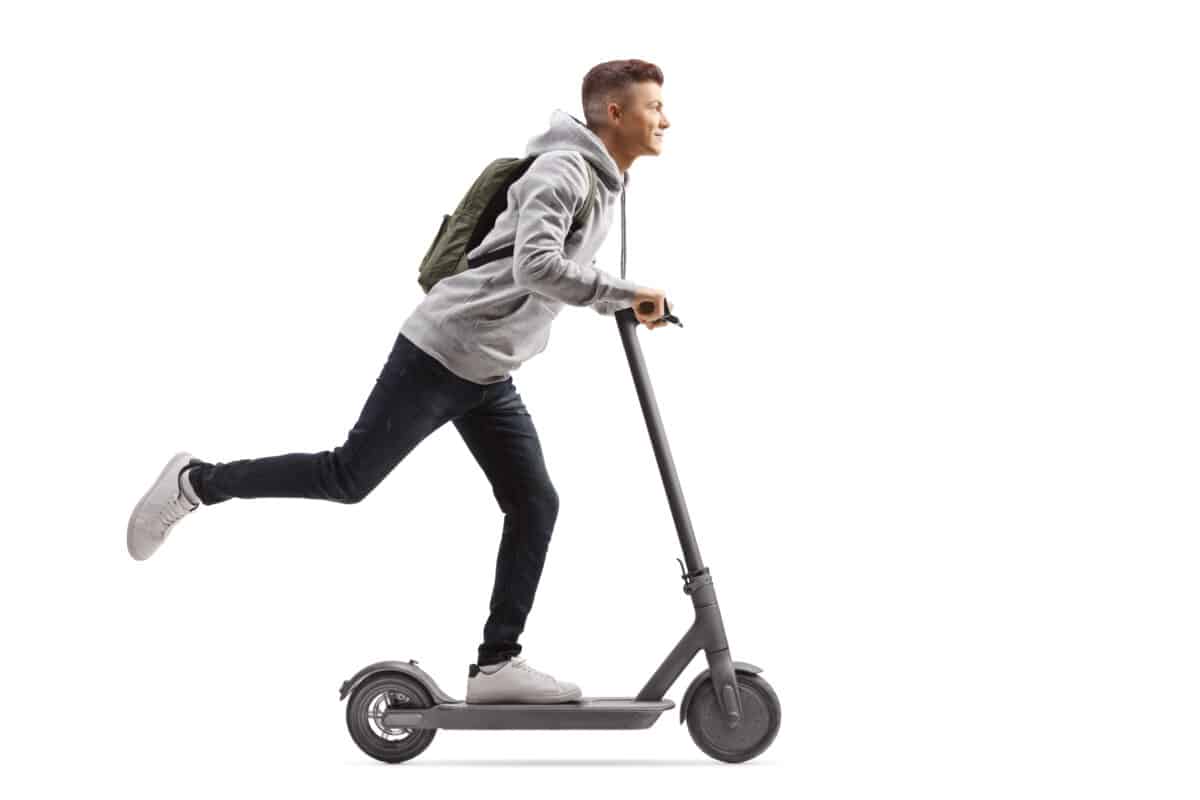 student riding an electric scooter