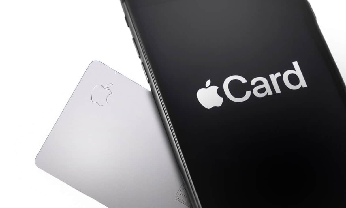 A physical Apple Card beside an iPhone displaying the Apple Card logo.