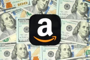 Amazon icon printed on paper and placed on money background.