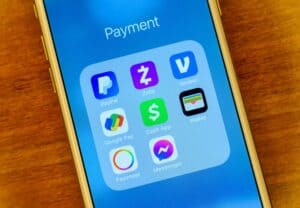 Apple Pay, Zelle, and other payment apps in a folder on an iPhone.