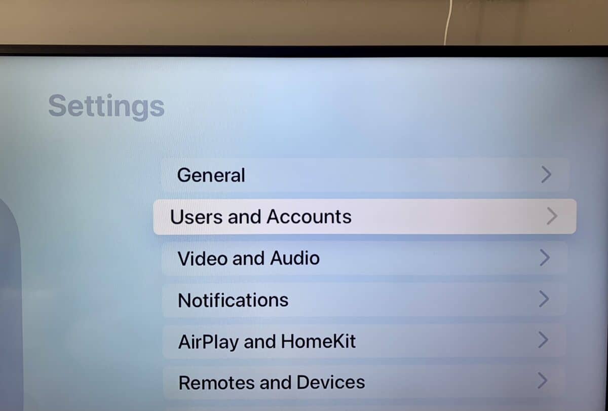 Users and Accounts tab highlighted in the Apple TV Settings app.
