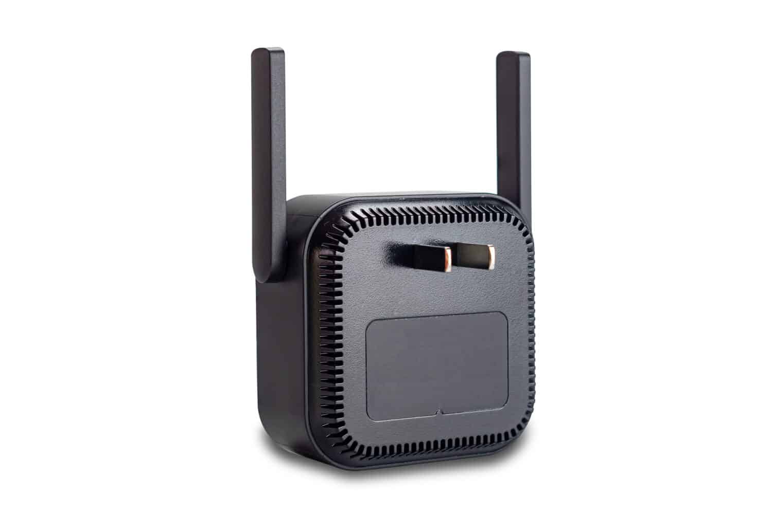 Back view of wireless wi-fi signal range extender or wireless internet repeater or wi-fi signal booster amplifier with adjustable antennas and pins for plugged in electric socket isolated on white.