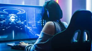 gamer girl playing video games on a gaming monitor
