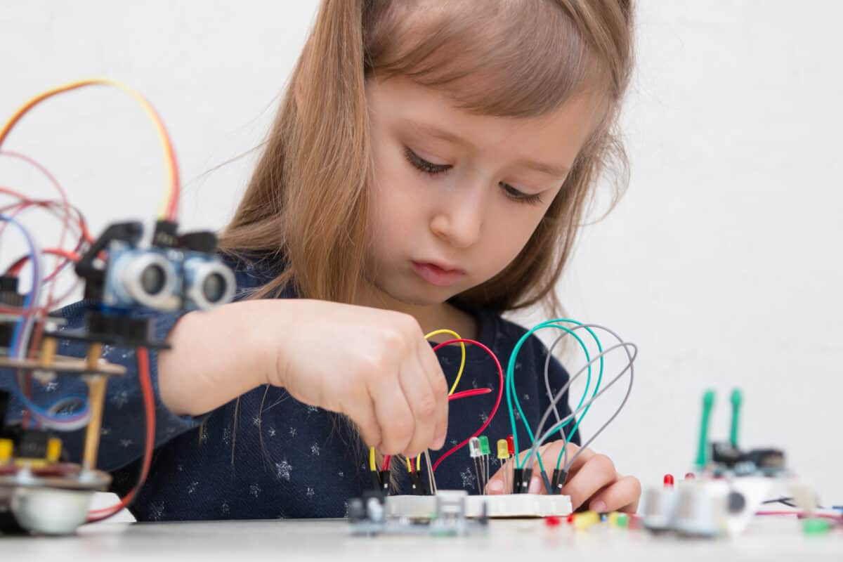 little girl building robot arduino board