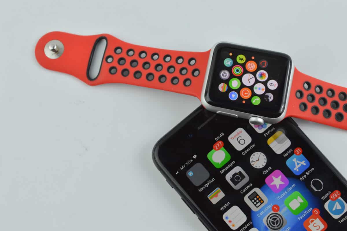 Apple Watch resting on iPhone screen.