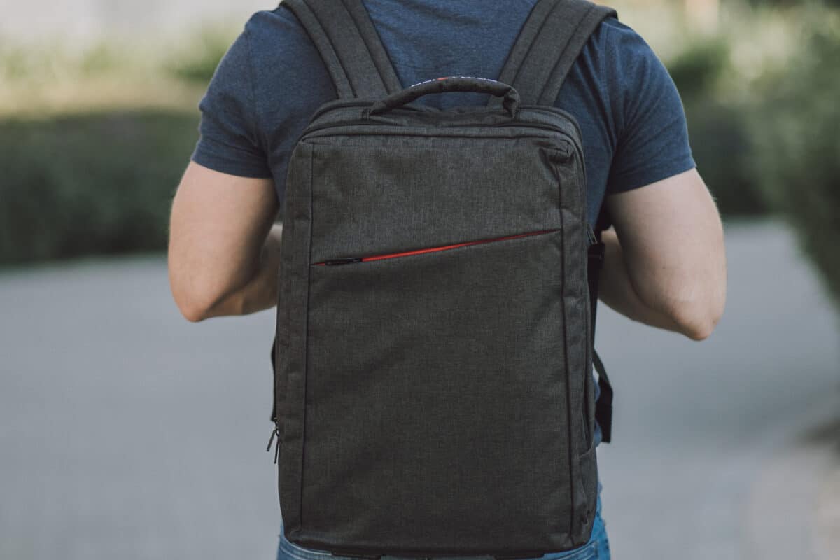 man wearing a laptop backpack