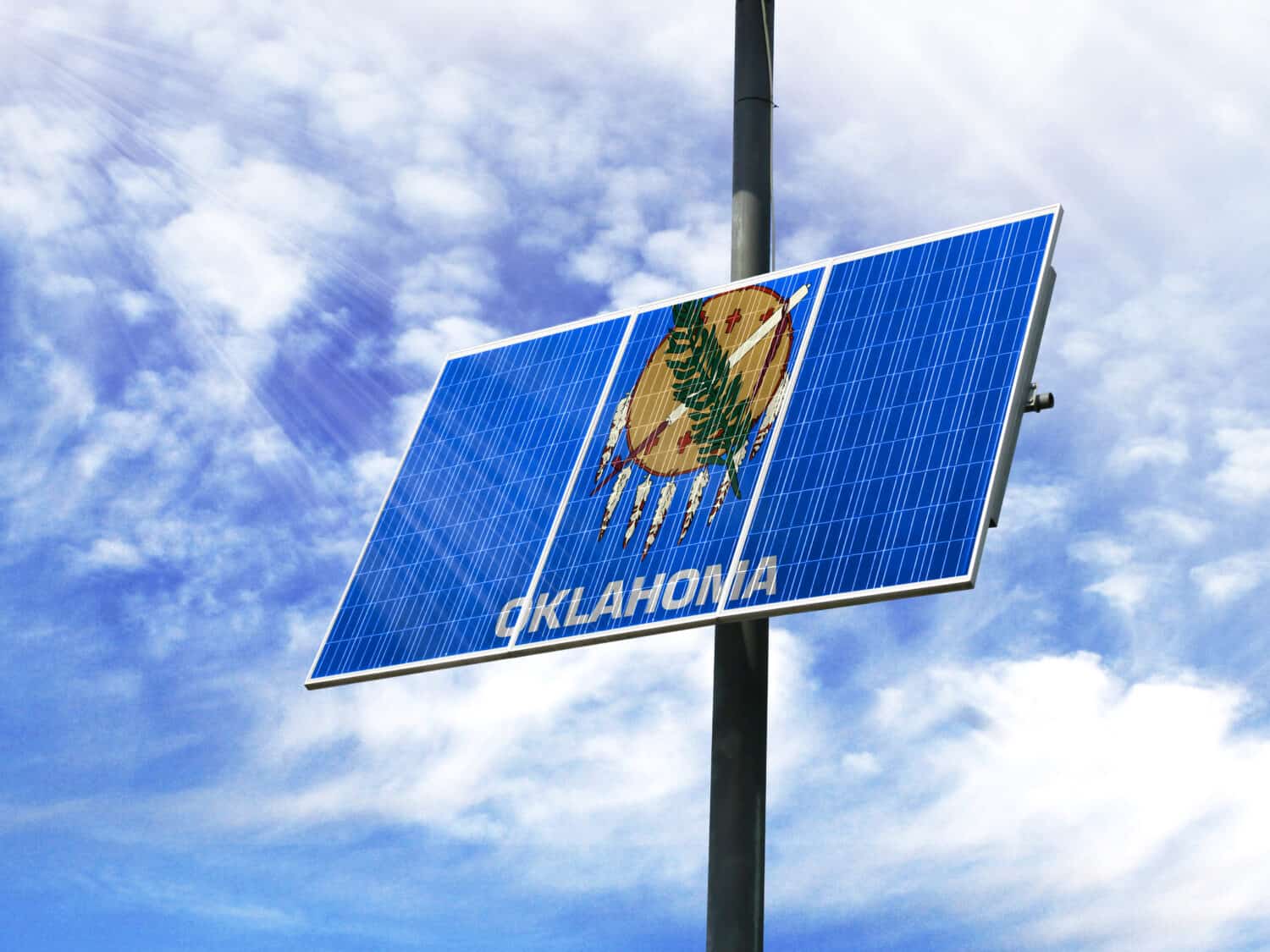 Solar panels against a blue sky with a picture of the flag State of Oklahoma