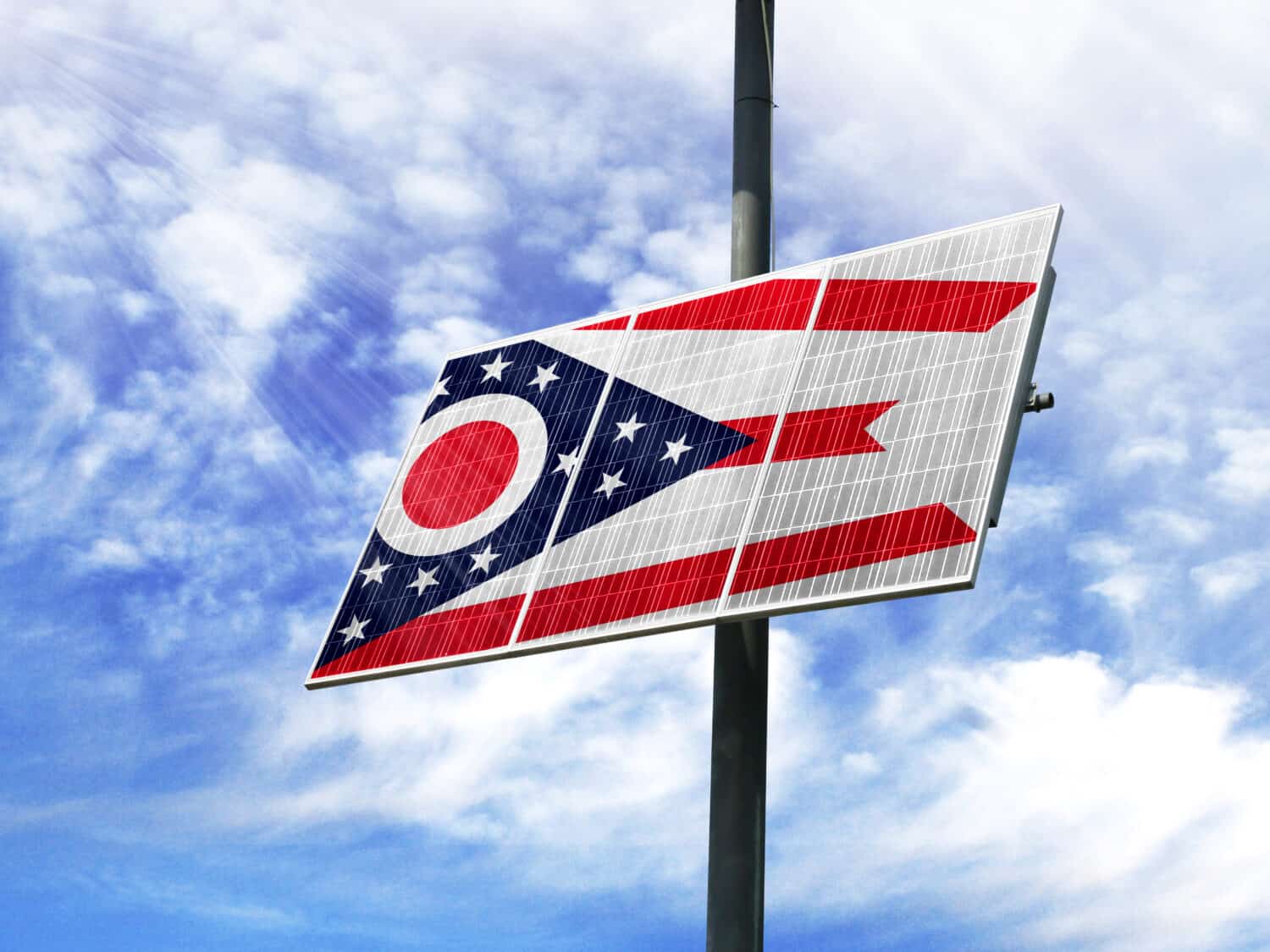 Solar panels against a blue sky with a picture of the flag State of Ohio