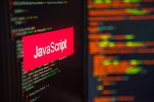 Programming language, JavaScript inscription on the background of computer code. Modern digital technologies and programming training