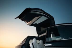 Modern and futuristic SUV car vertical door. Expensive and luxury crossover with falcon wings style door