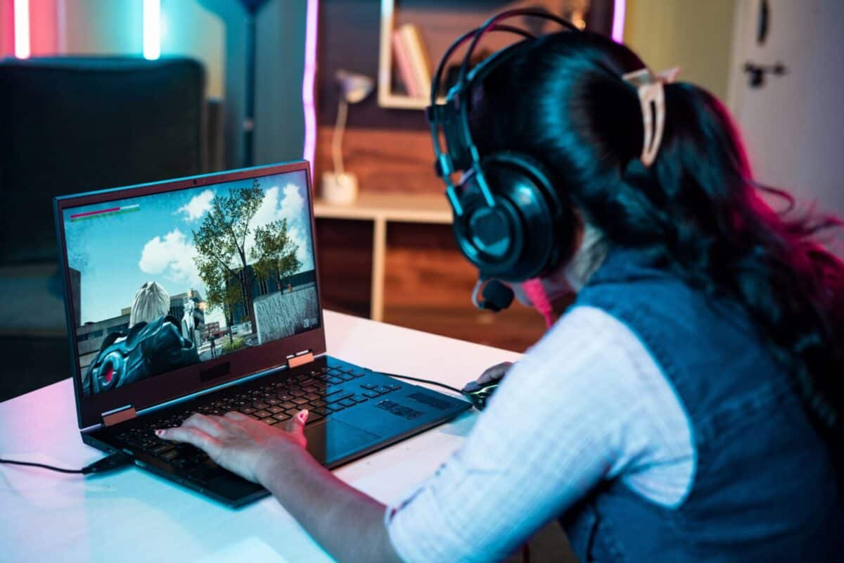 Woman playing game on laptop.