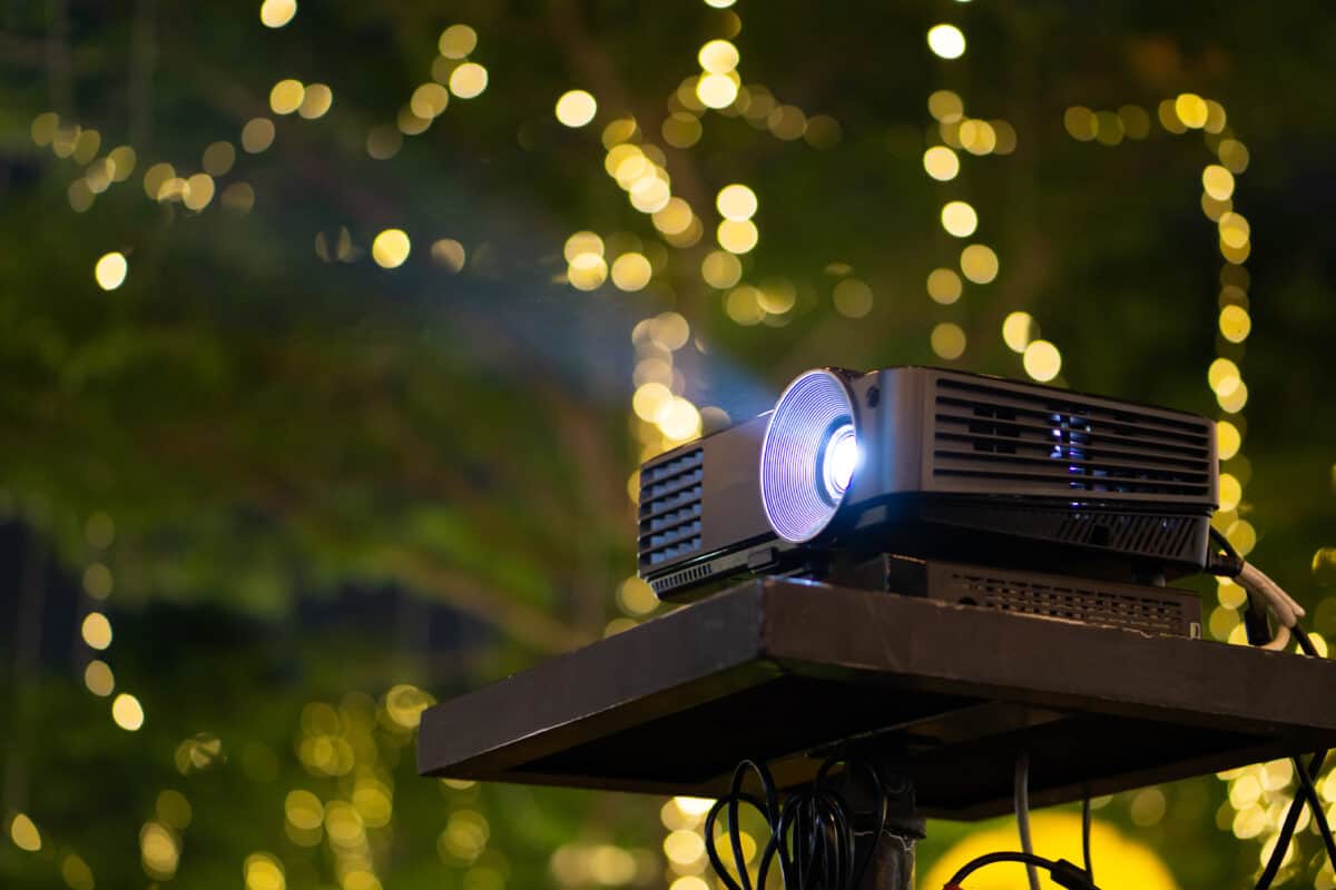 Projector displaying images in an outdoor setting.