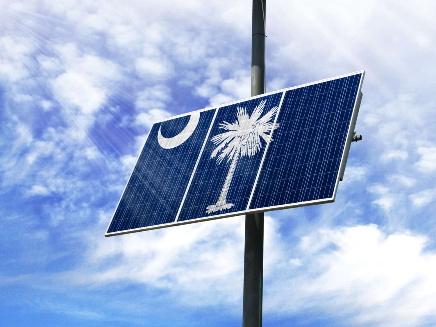 Solar panels against a blue sky with a picture of the flag State of South Carolina