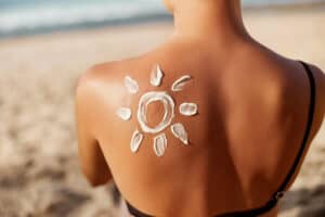 Woman applying one of Reddit's 7 best sunscreens
