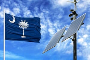 Solar panels on a background of blue sky with a flagpole and the flag State of South Carolina