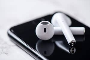 Pair of white wireless earbuds for smartphone. Relaxation concept.