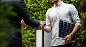 Engineer and solar power customer shake hands
