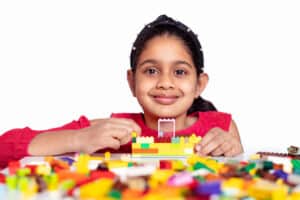 kid girl with LEGO blocks set