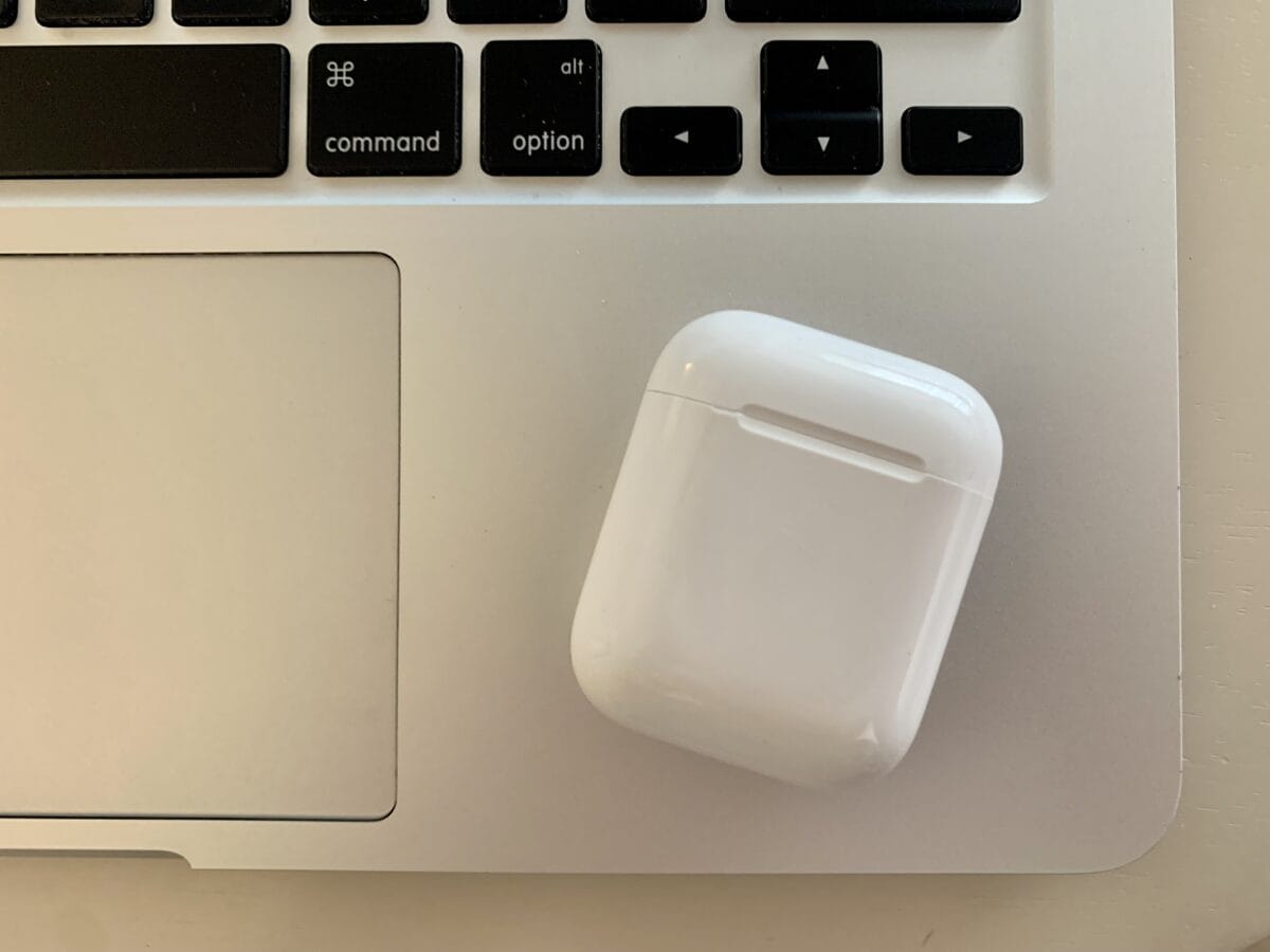 AirPods case resting on MacBook.