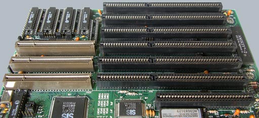 A close up of a motherboard with several ISA slots and VESA local buses.