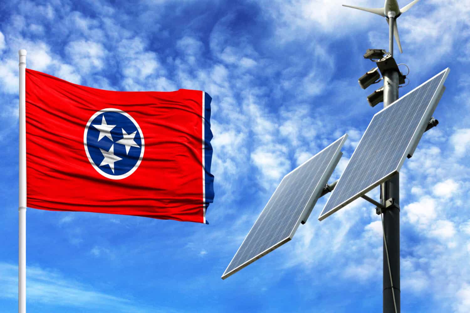 Solar panels on a background of blue sky with a flagpole and the flag State of Tennessee