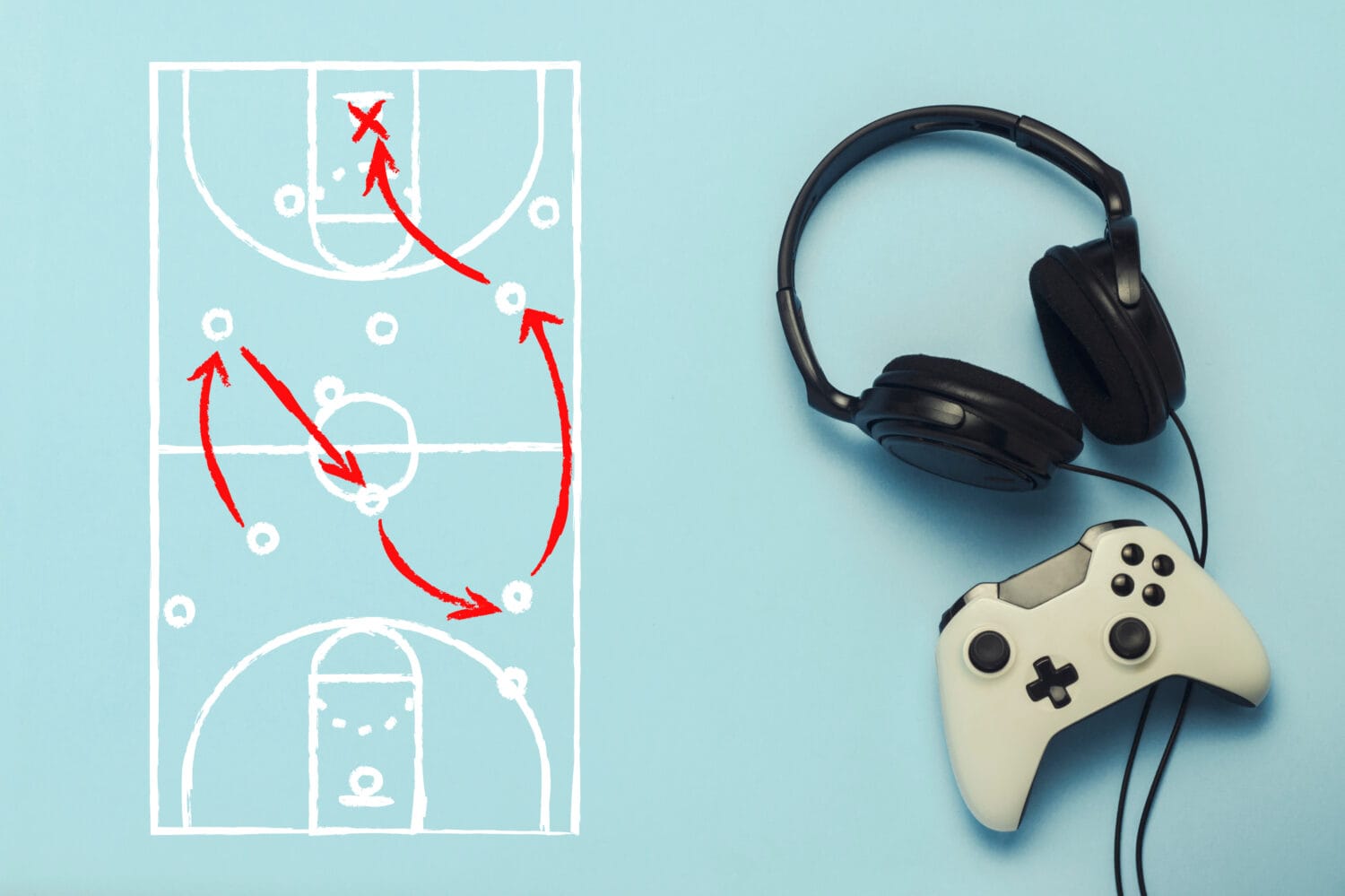 Headphones and gamepad on a blue background. Added drawing with the tactics of the game. Basketball. The concept of computer games, entertainment, gaming, leisure. Flat lay, top view.