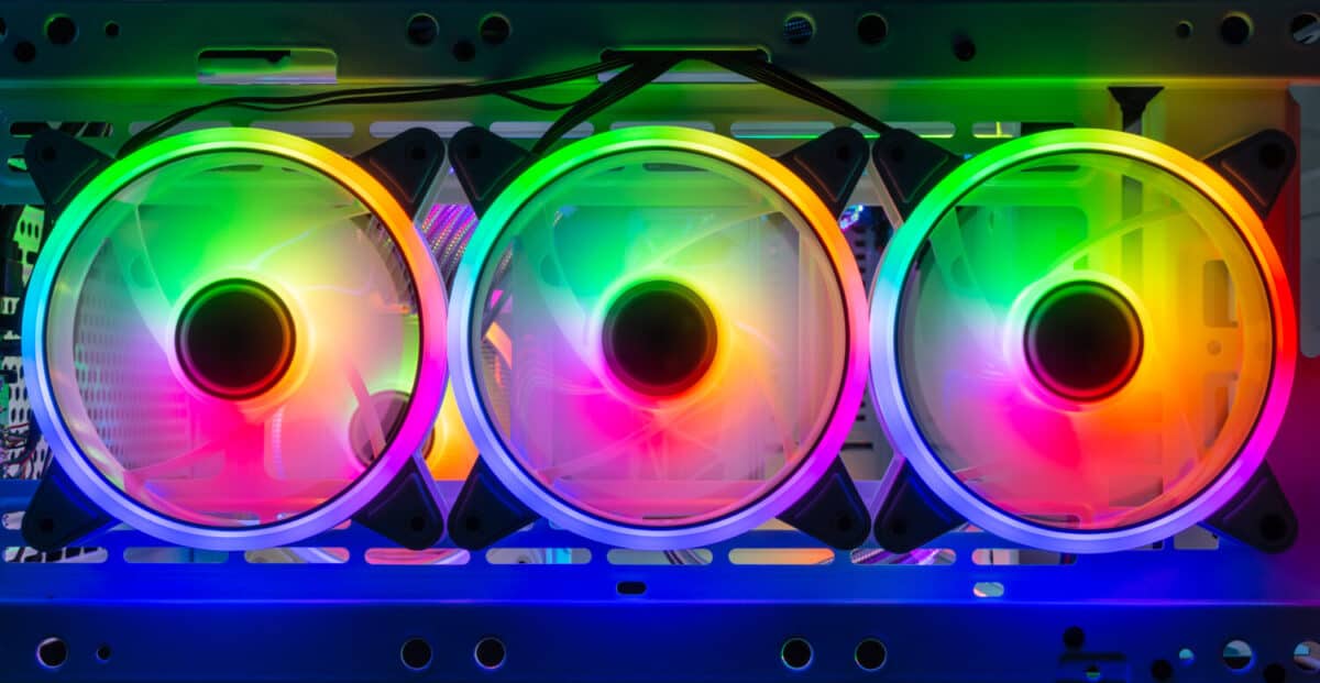 three colorful bright rainbow led rgb pc fan air case cooler in white desktop computer chassis. gaming modding water cooling and technology concept background
