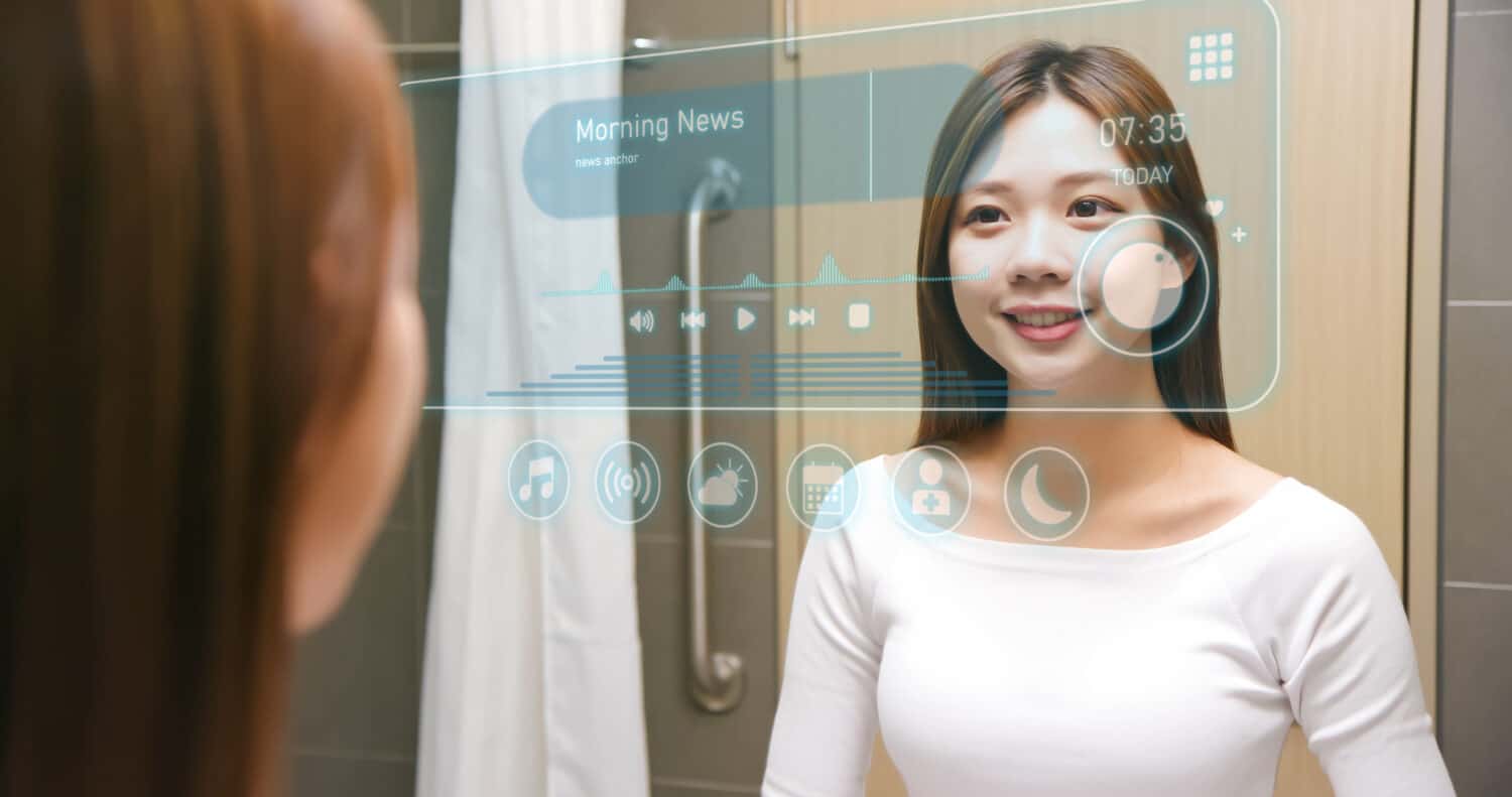 Asian woman looking smart mirror screen at bathroom while waking up - listening to morning news today having fun in modern home