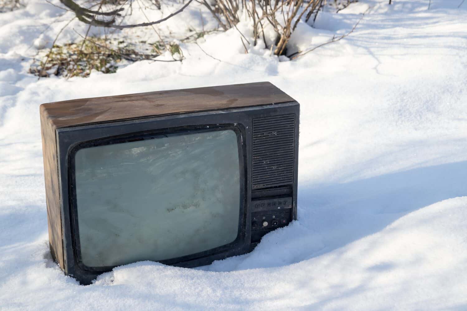 Vintage TV set sitting in the snow